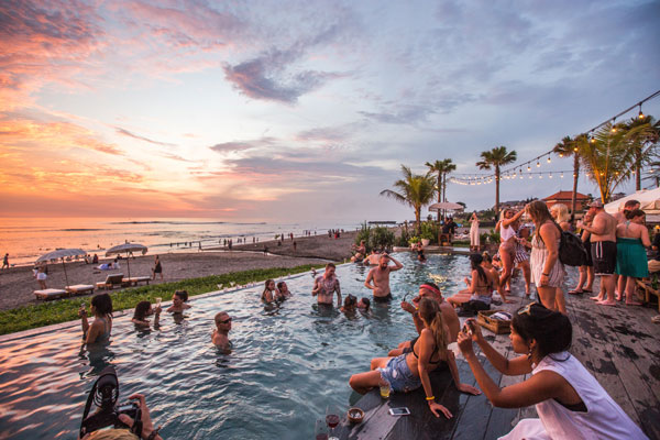 A busy beach bar in Canggu during sunset hour