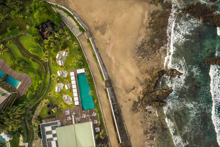 COMO Uma Canggu Aerial view of the COMO Beach Club pool and the beach 768x512