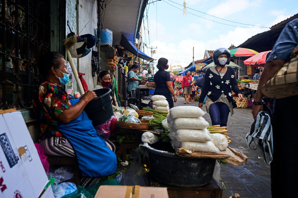 Sellers and buyers are wearing mask at Badung market