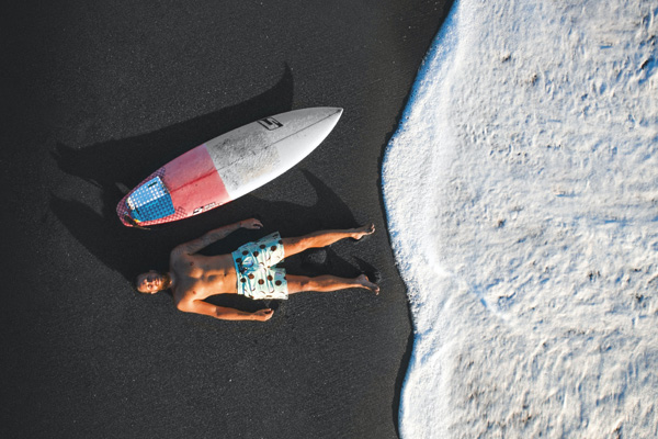 A surfer resting at Berawa beach