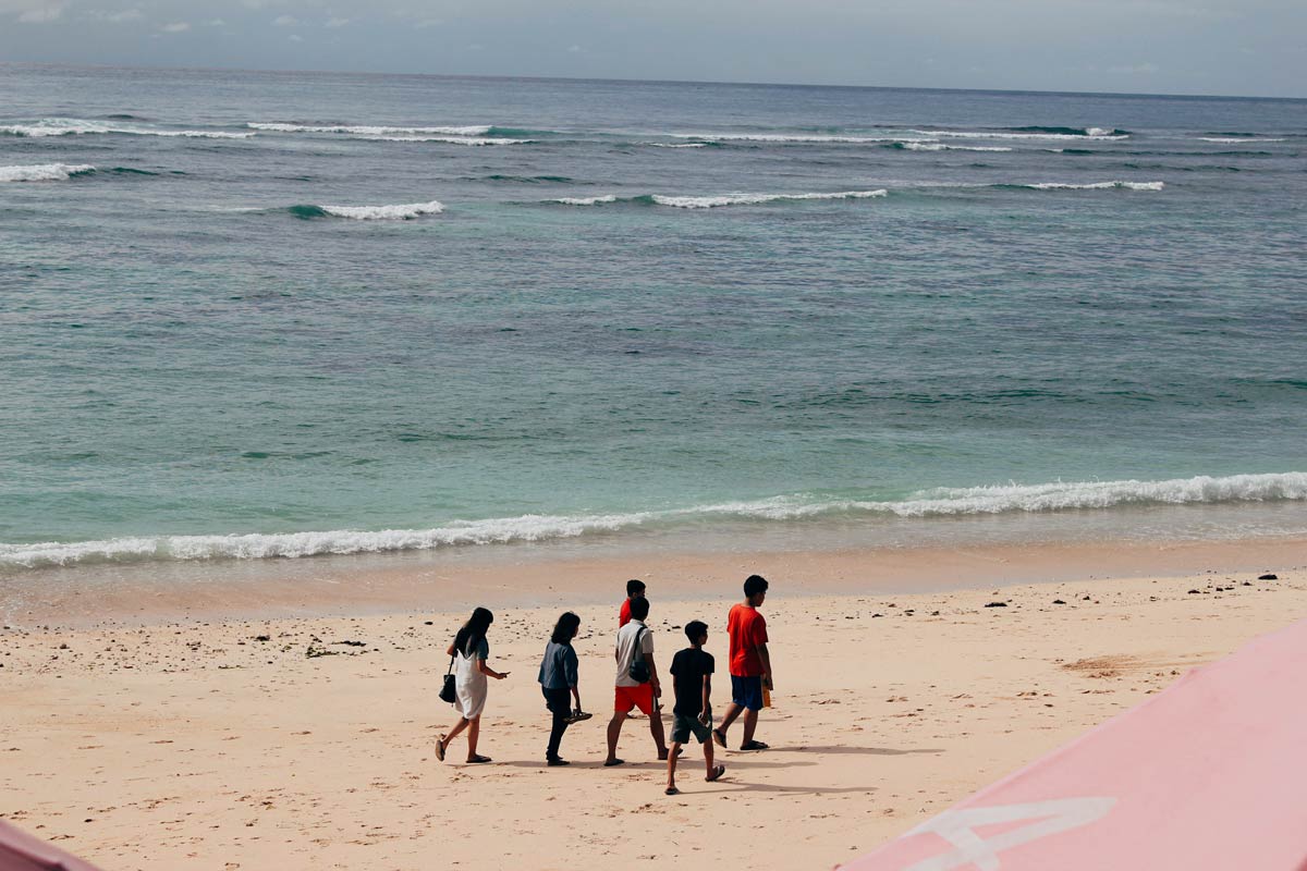 Local teenagers walking in Kuta Beach