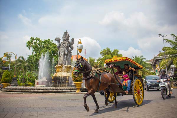 Tourist riding horse cart in Denpasar